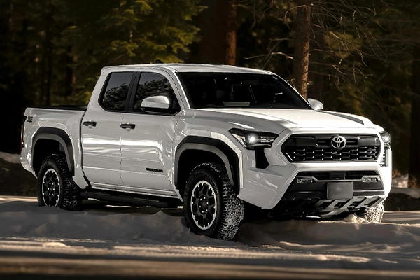 White Toyota Tacoma 4x4 parked on snow