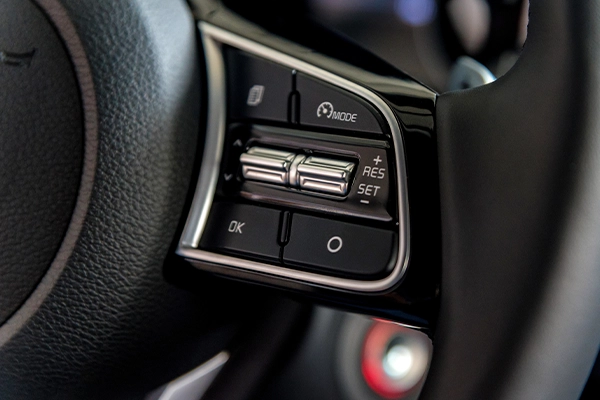 Cruise control dials and switches on the steering wheel of car